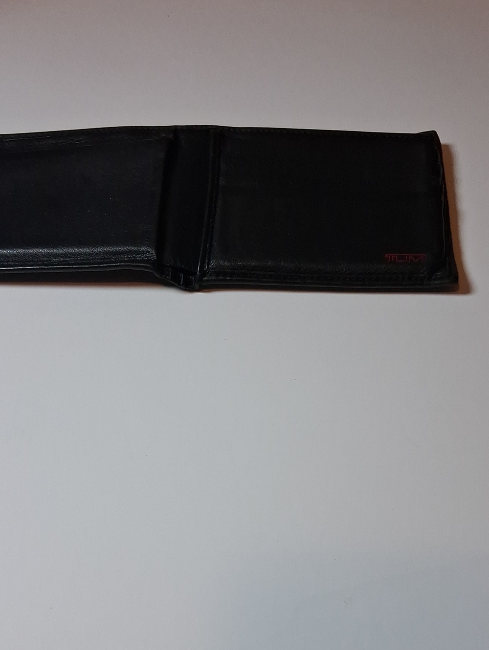 Tumi Black Leather Money Clip Wallet with Subtle Red Logo